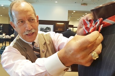 Robert Rosenthal adjusts a display tie at Brooks Brothers Biltmore Fashion Park store. (Photo by Josh Coddington/GPCC)
