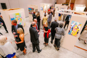 Guest conversing at American Association of Home Arts (AAHA) art exhibition